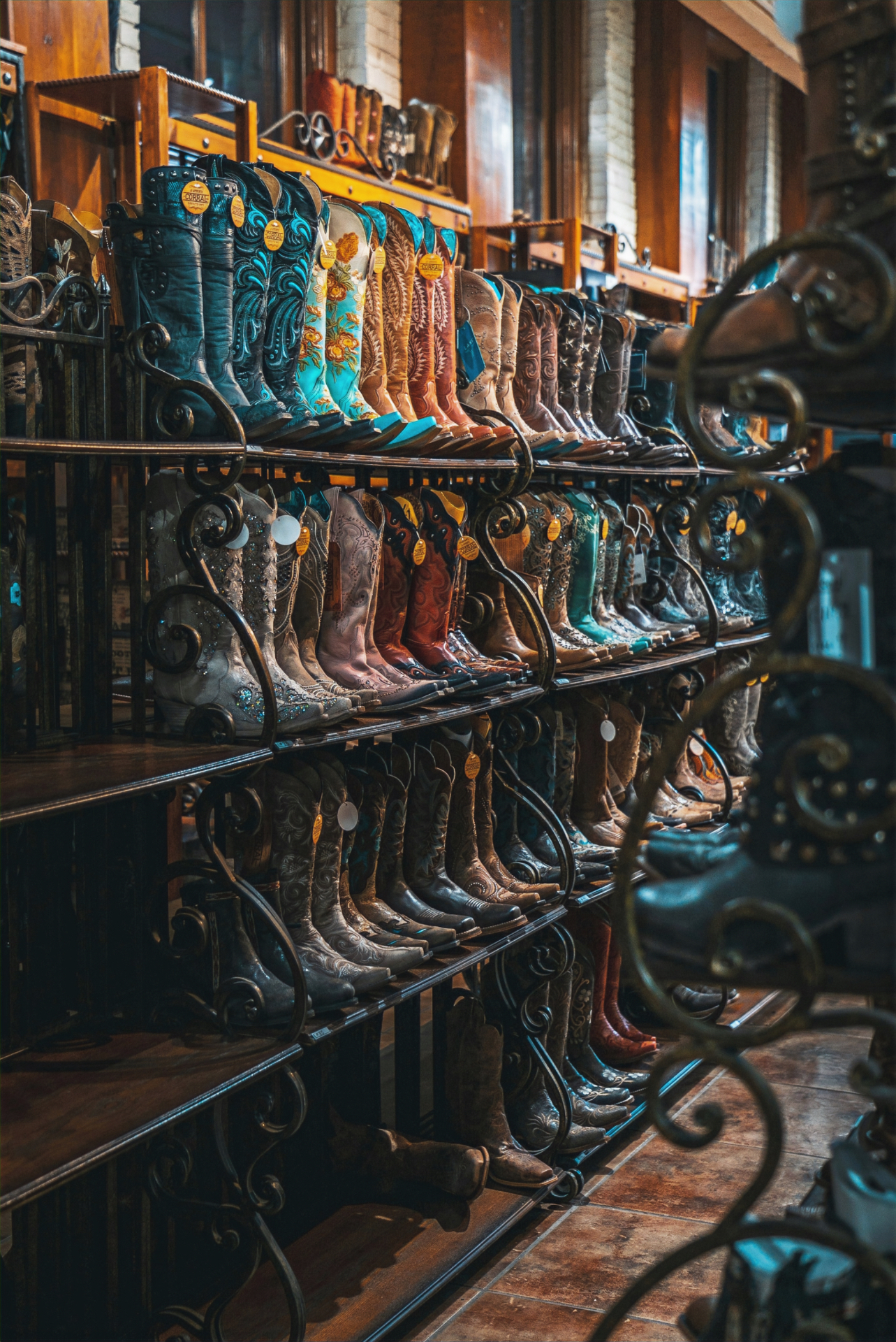 Cowboy boots and hats lined up inside Santa Maria Western Wear